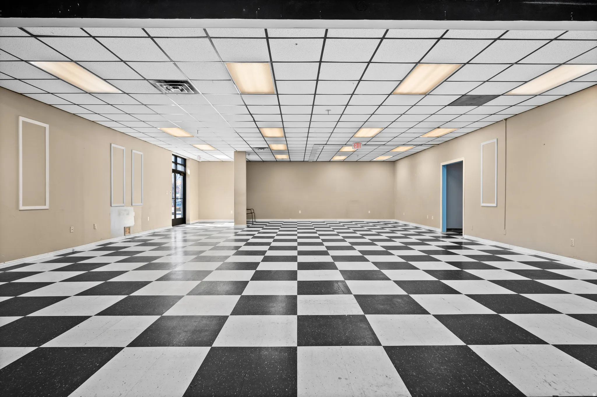 Spare room featuring a drop ceiling and dark flooring