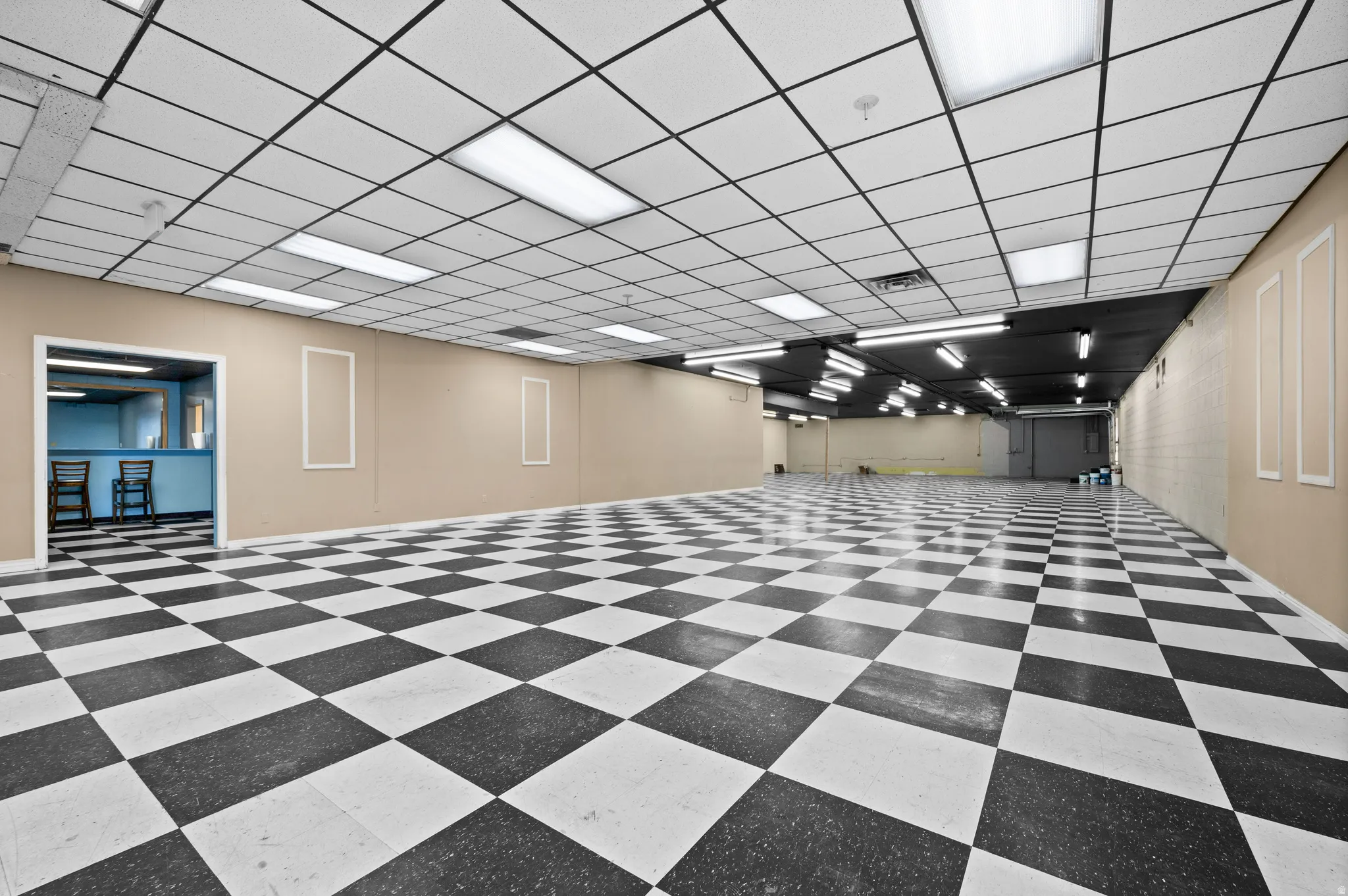 Below grade area featuring tile patterned floors and a drop ceiling