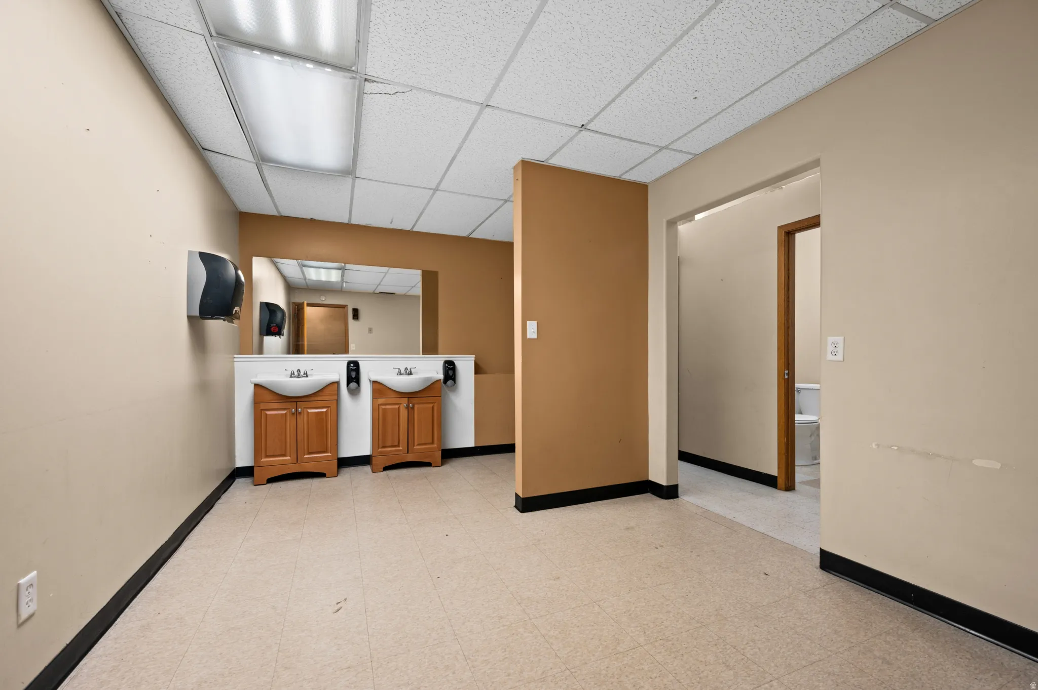 Kitchen with a paneled ceiling and brown cabinetry