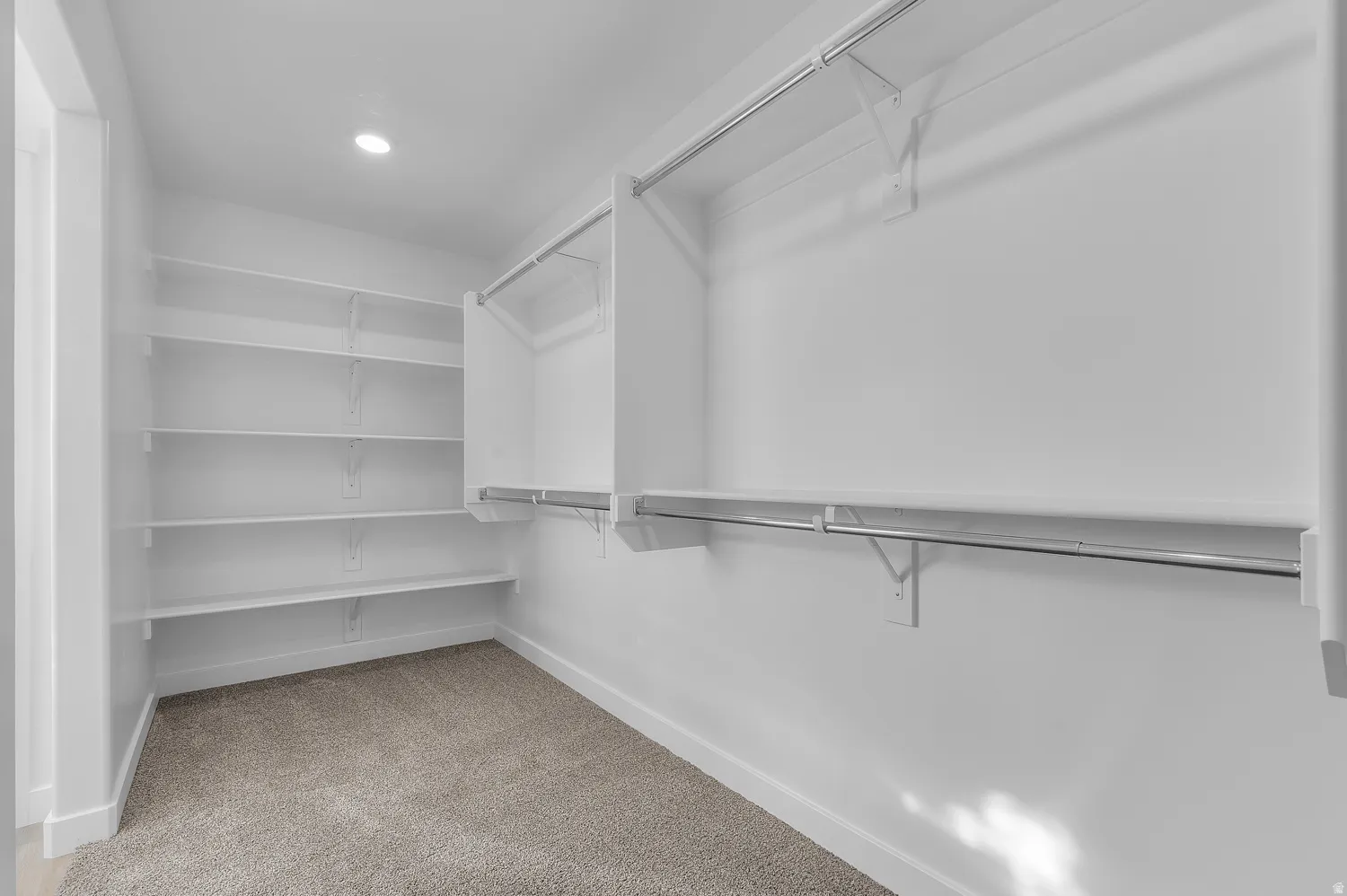 Walk in closet featuring light carpet