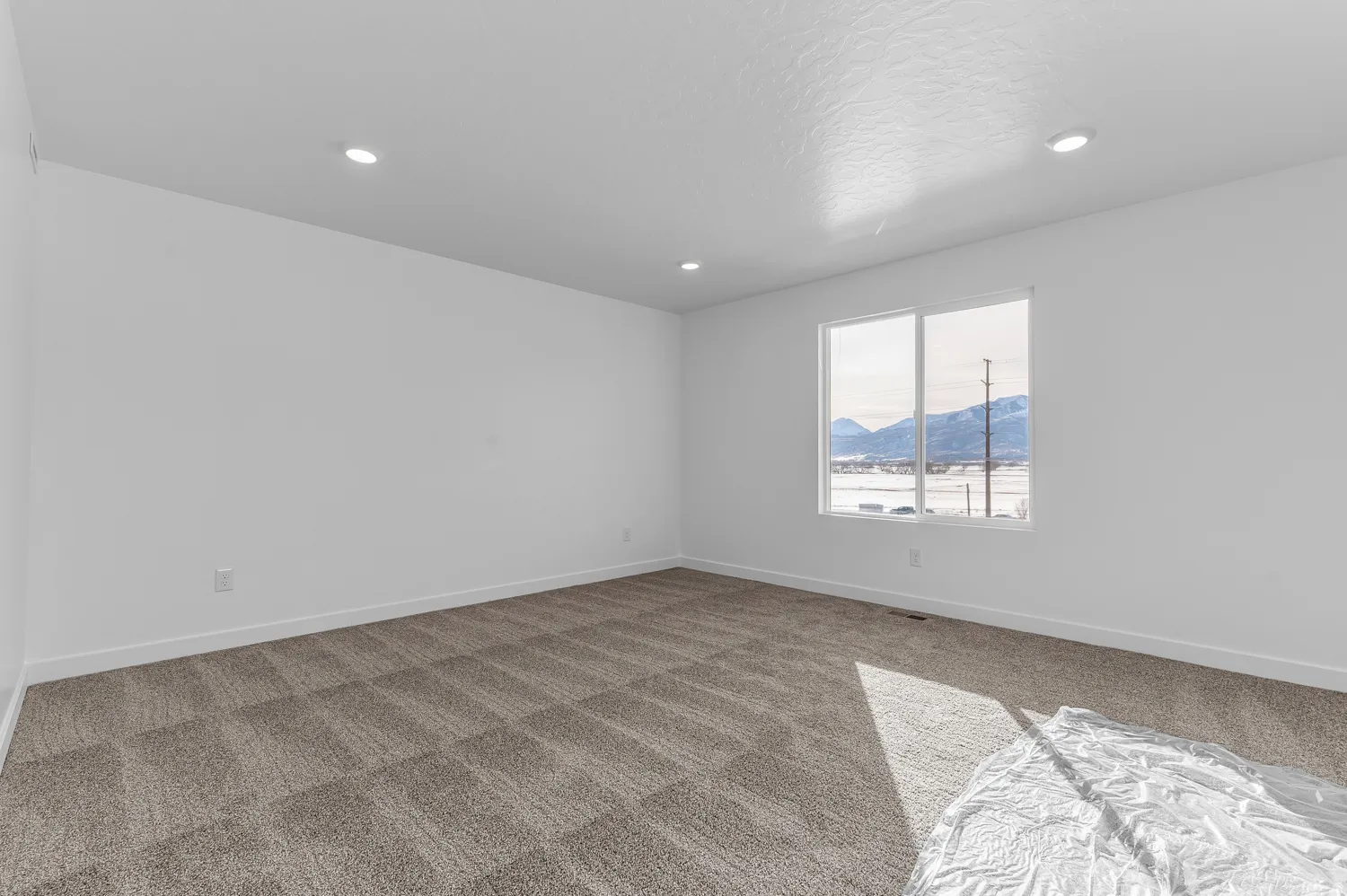 Unfurnished room featuring a mountain view, carpet floors, and recessed lighting