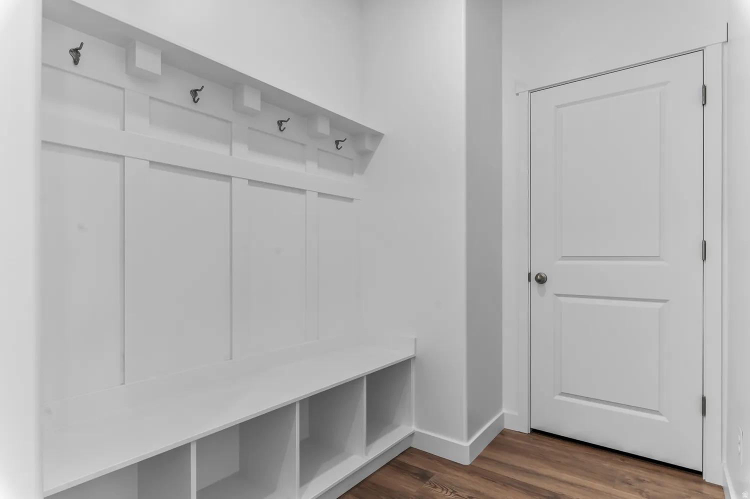Mudroom featuring dark wood finished floors and baseboards