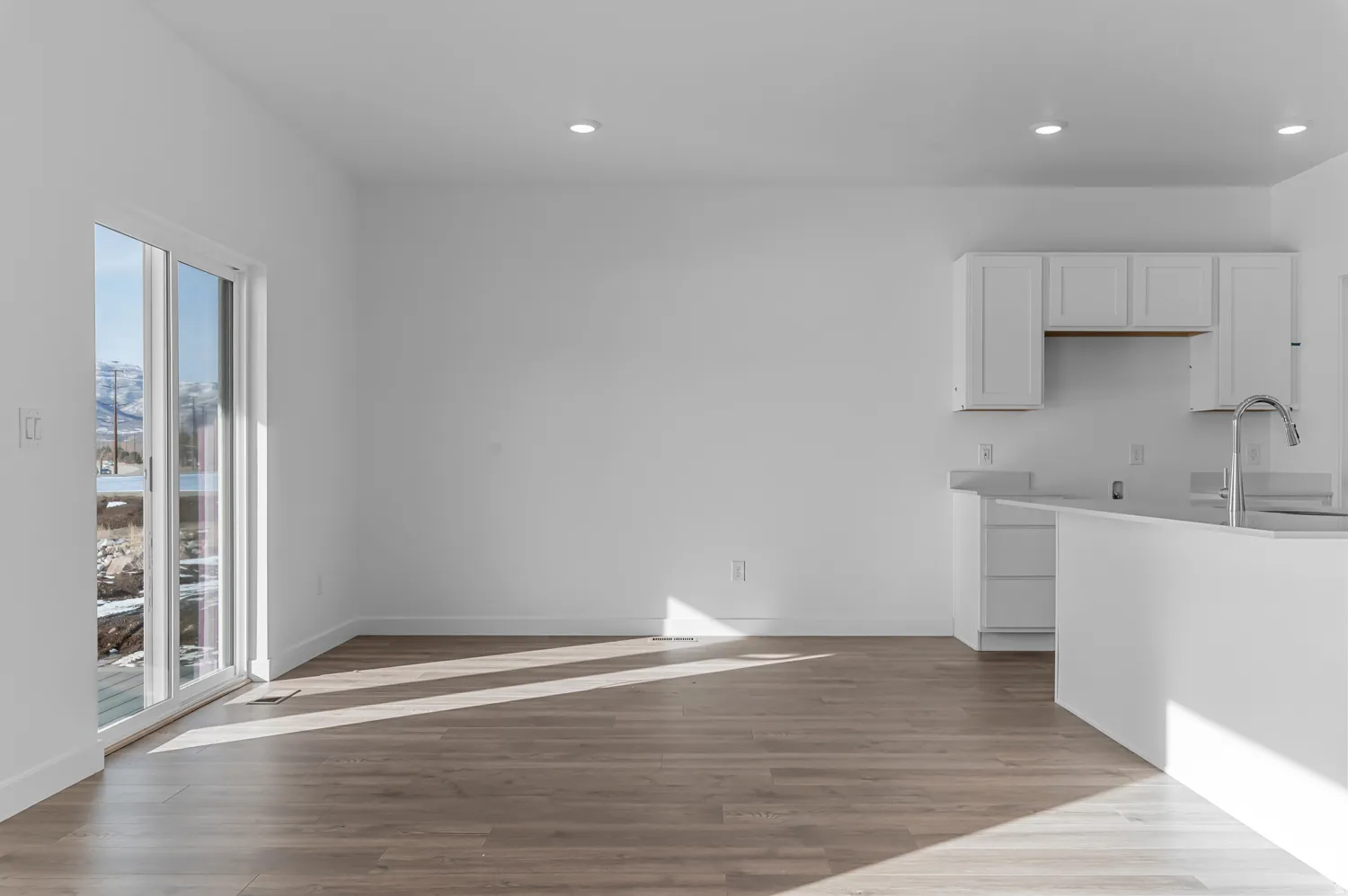 Kitchen with white cabinetry, dark wood-style flooring, and recessed lighting