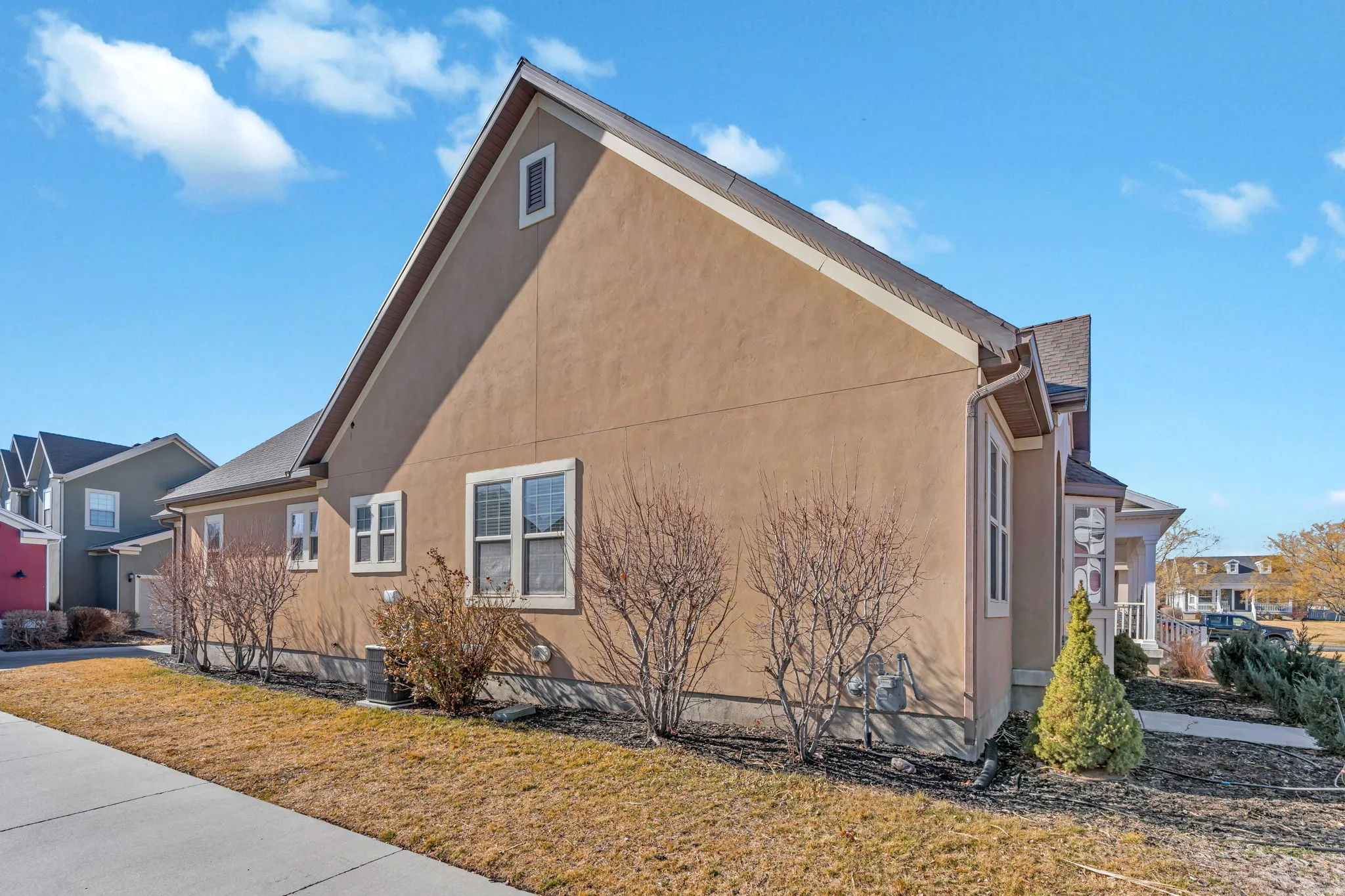 View of property exterior featuring stucco siding and a yard