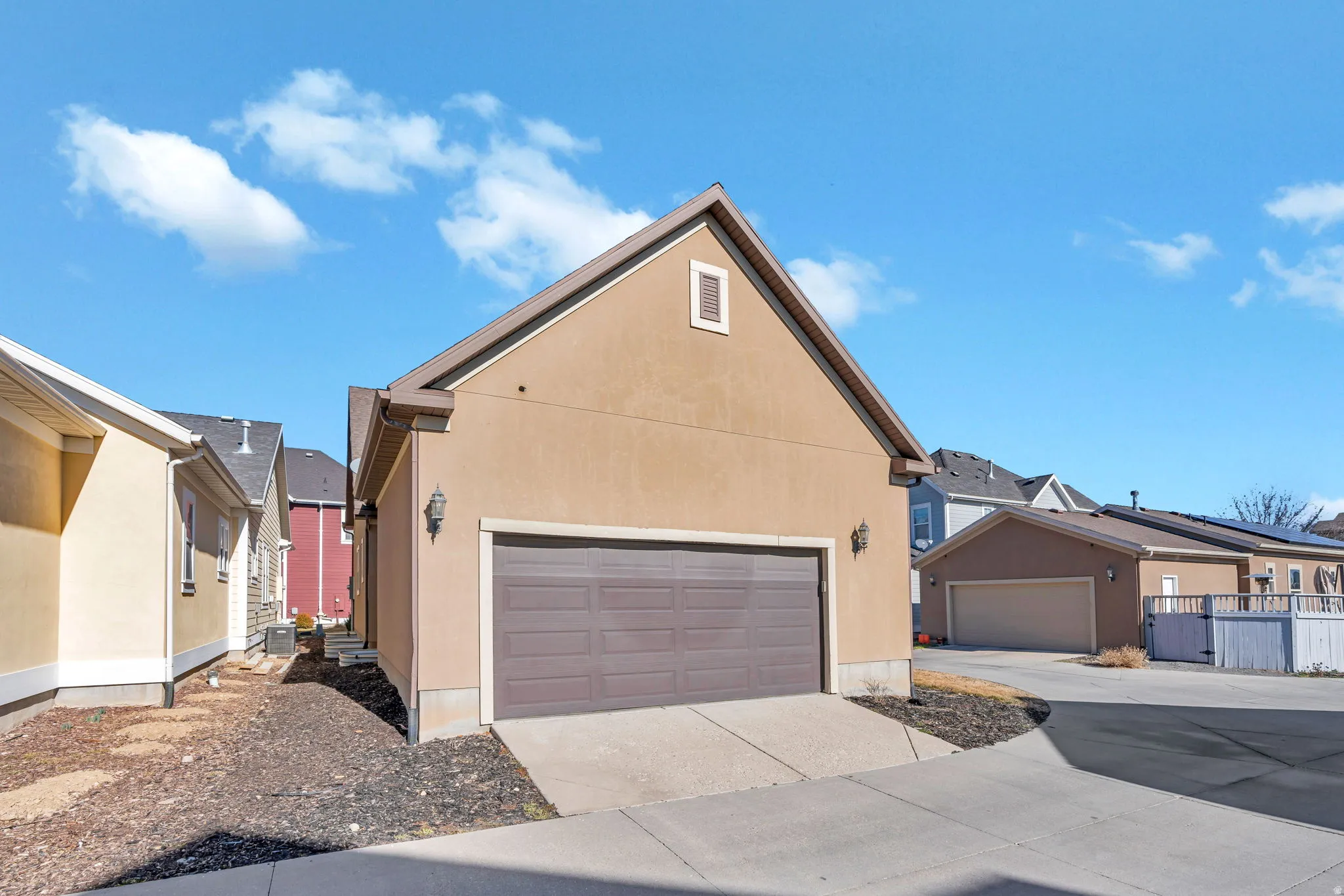 Traditional-style house with concrete driveway and stucco siding