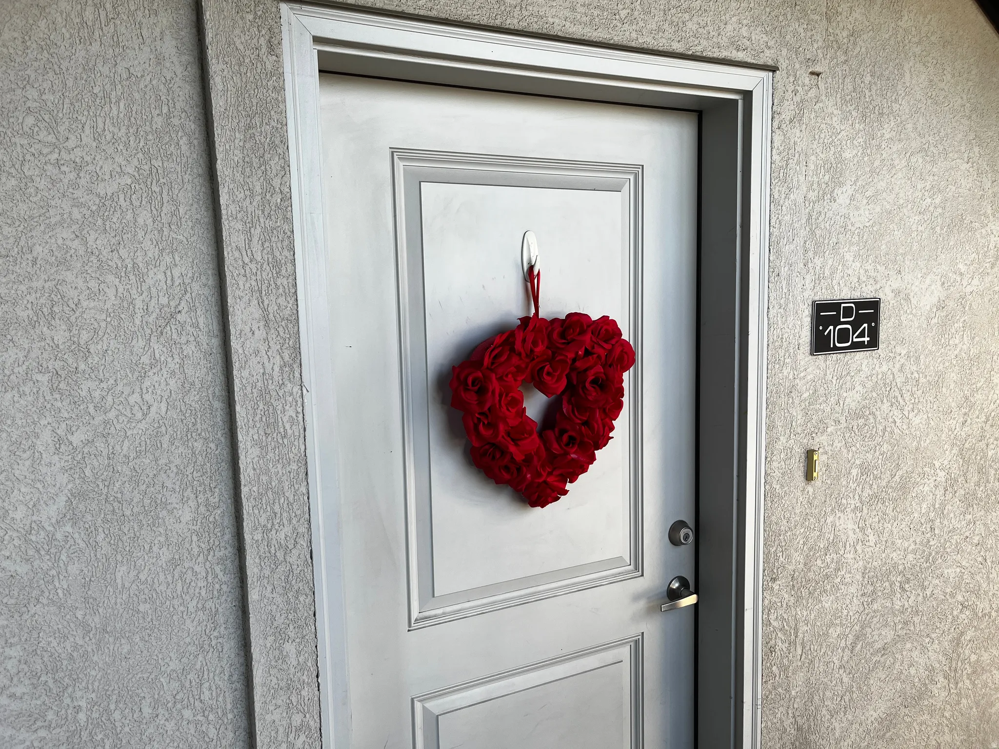 Doorway to property featuring stucco siding