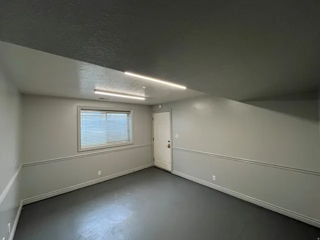 Below grade area featuring a textured ceiling and baseboards