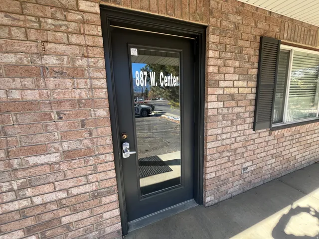 View of exterior entry with brick siding