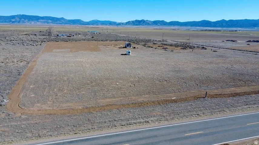 Aerial view of sparsely populated area featuring a mountainous background