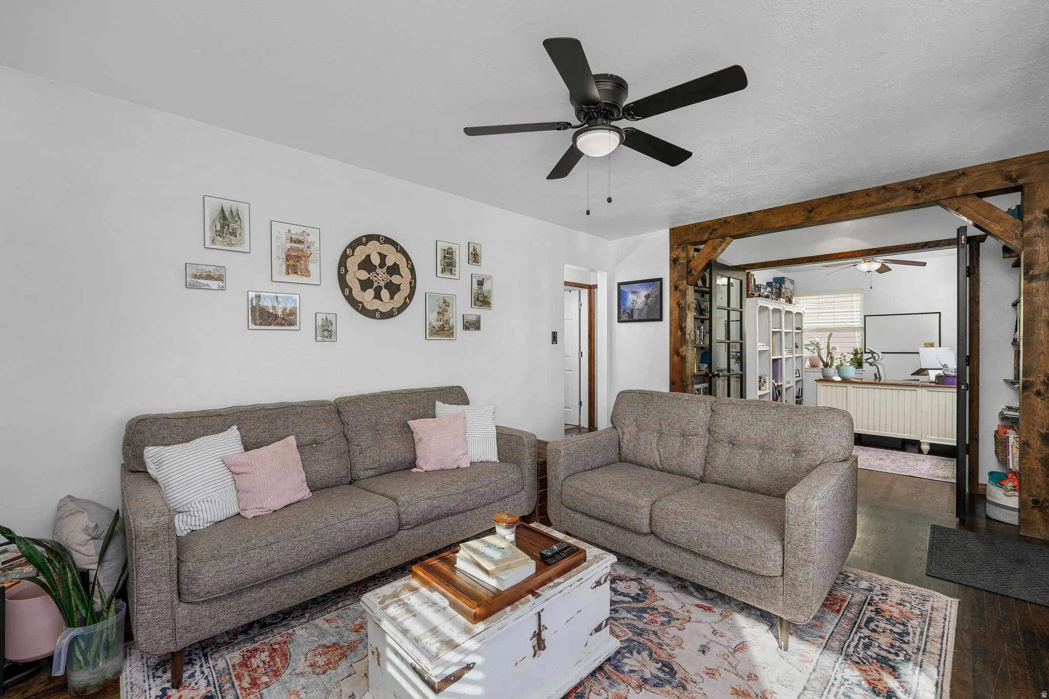 Living area with wood-type flooring and ceiling fan