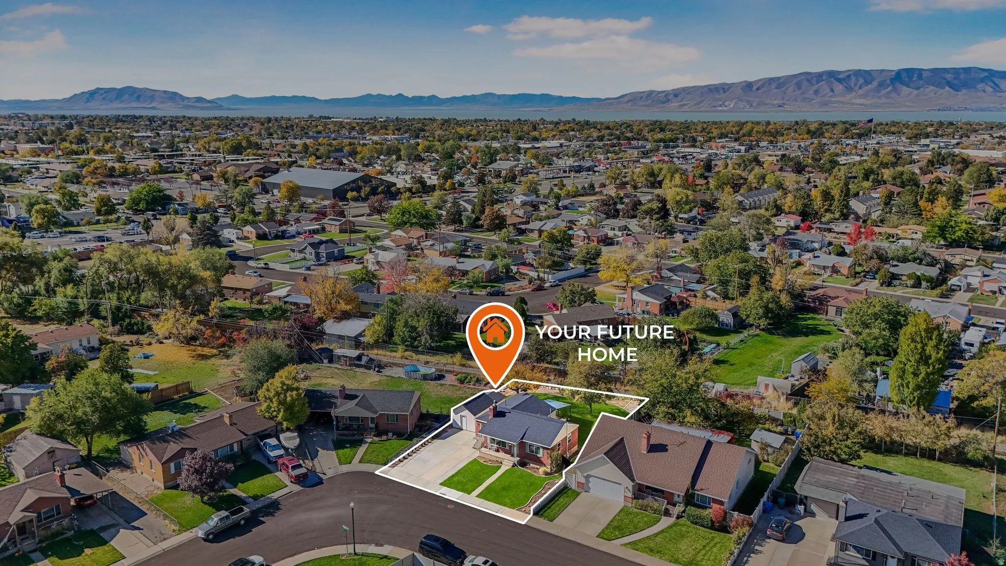 Aerial view of property's location with a mountain backdrop and nearby suburban area