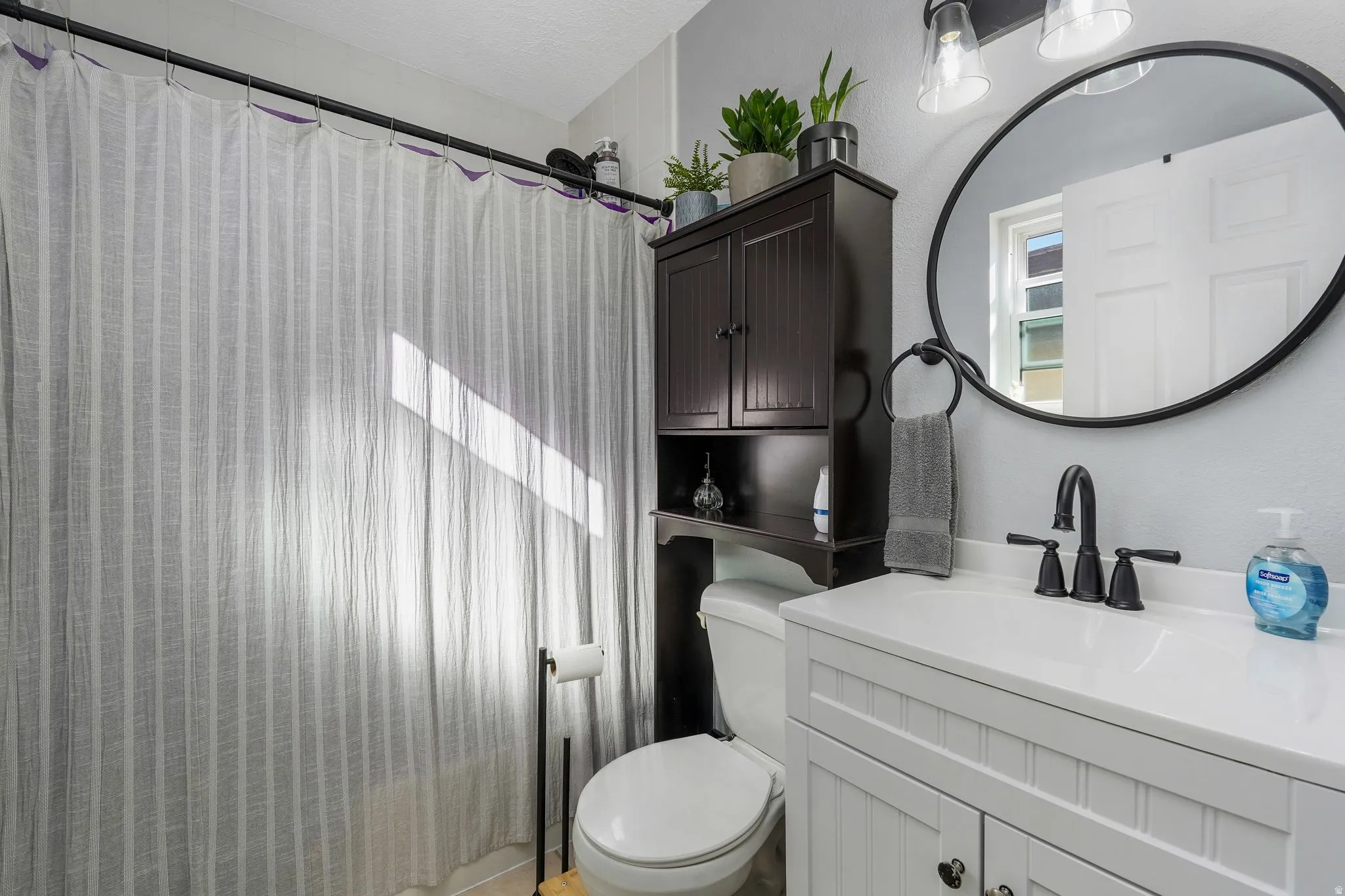 Full bath featuring vanity and curtained shower