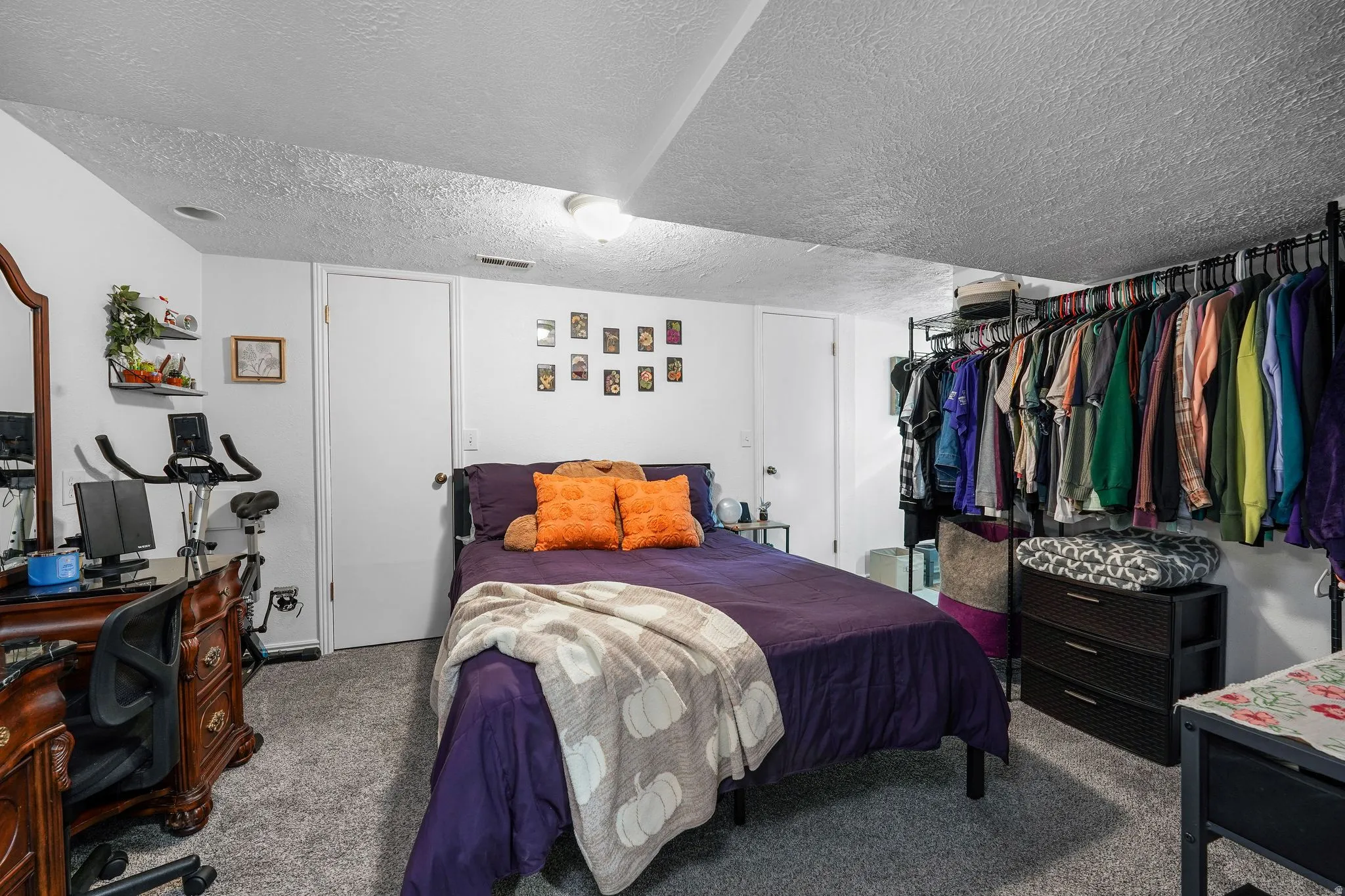 Bedroom with a textured ceiling, a closet, and carpet flooring