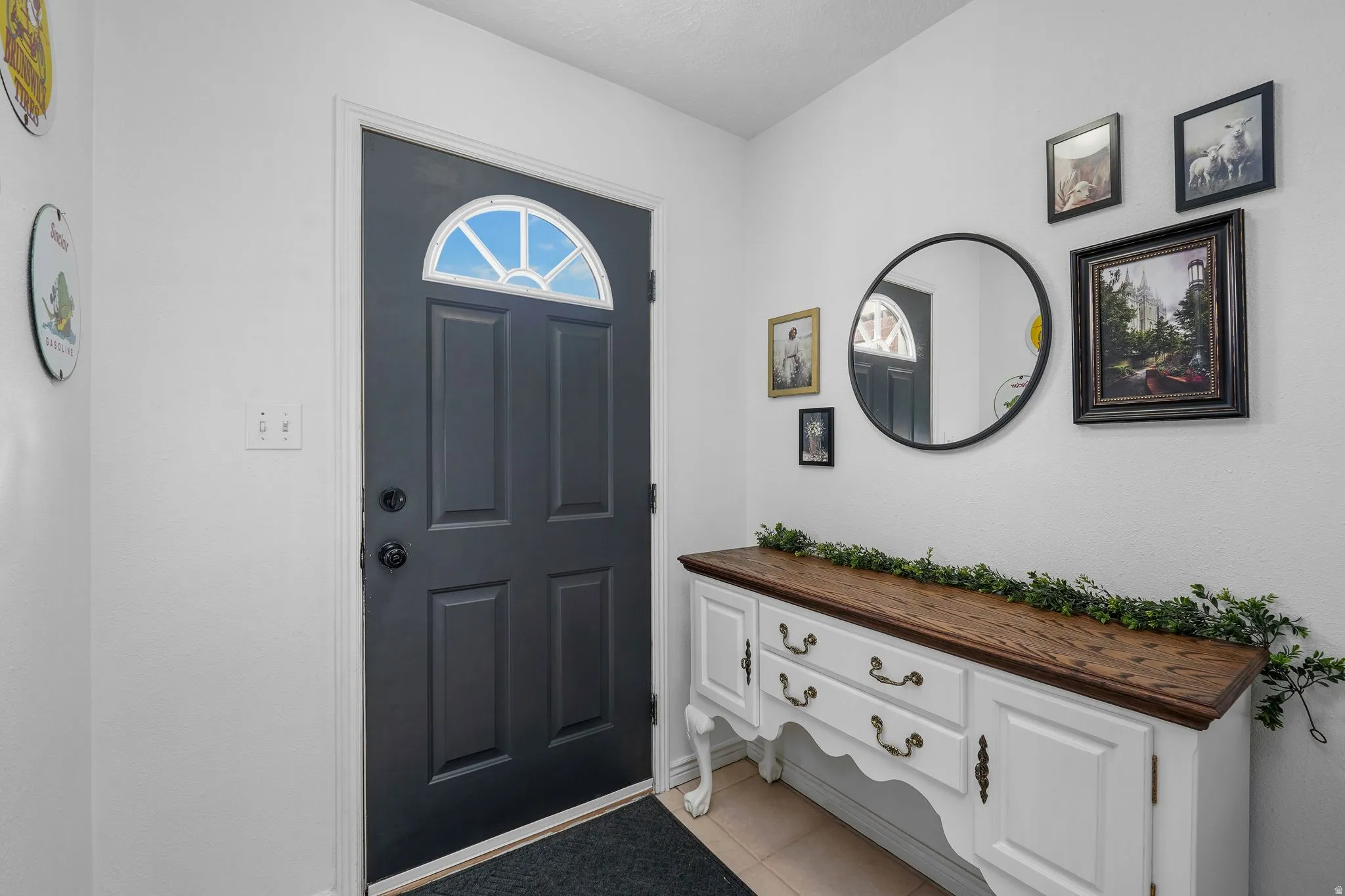 Foyer entrance featuring light tile patterned floors