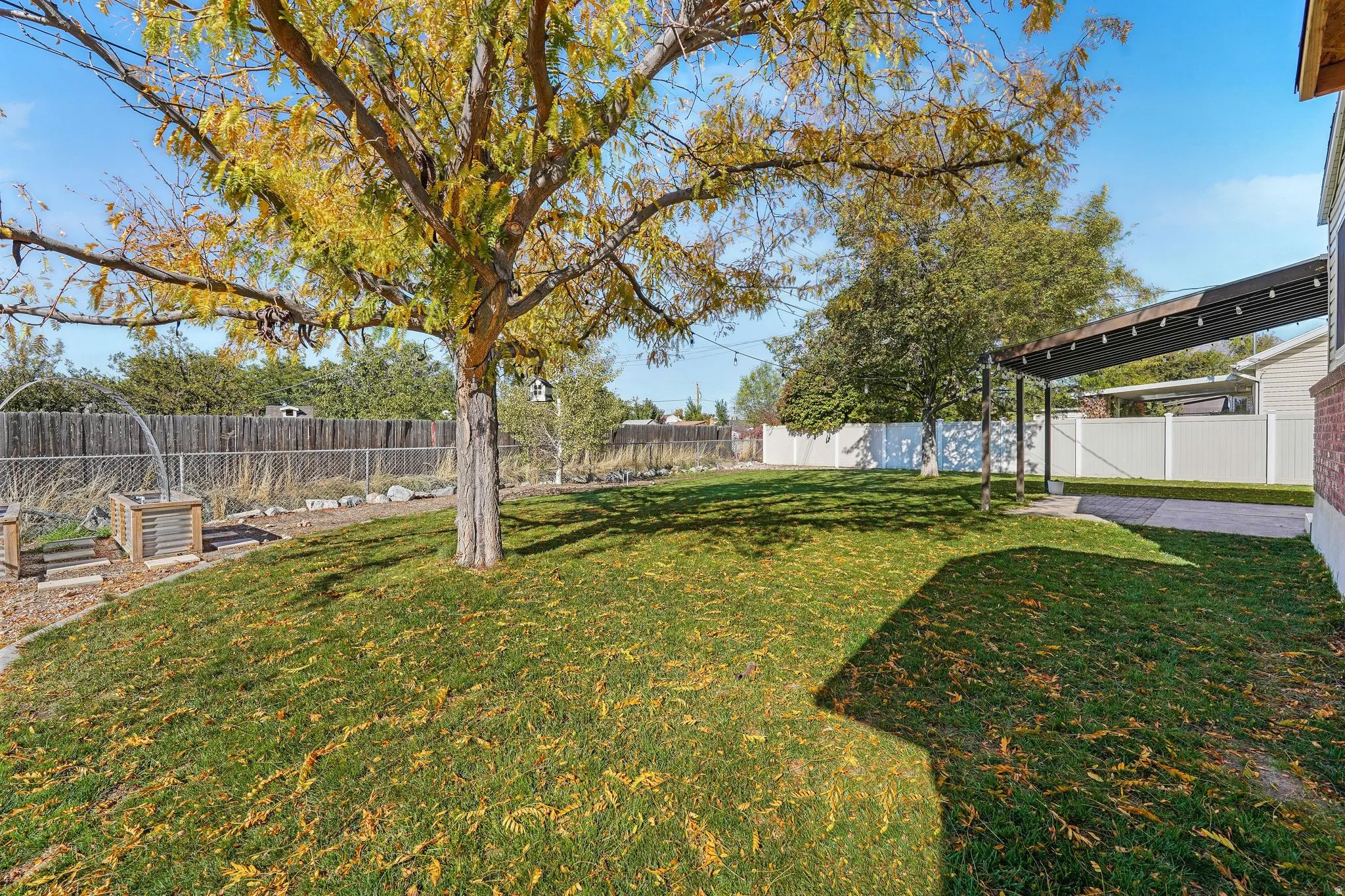 Fenced backyard with a patio area