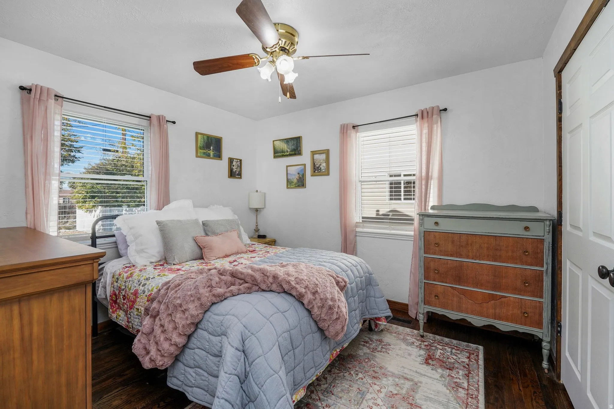 Bedroom with a ceiling fan, dark wood finished floors, and a closet