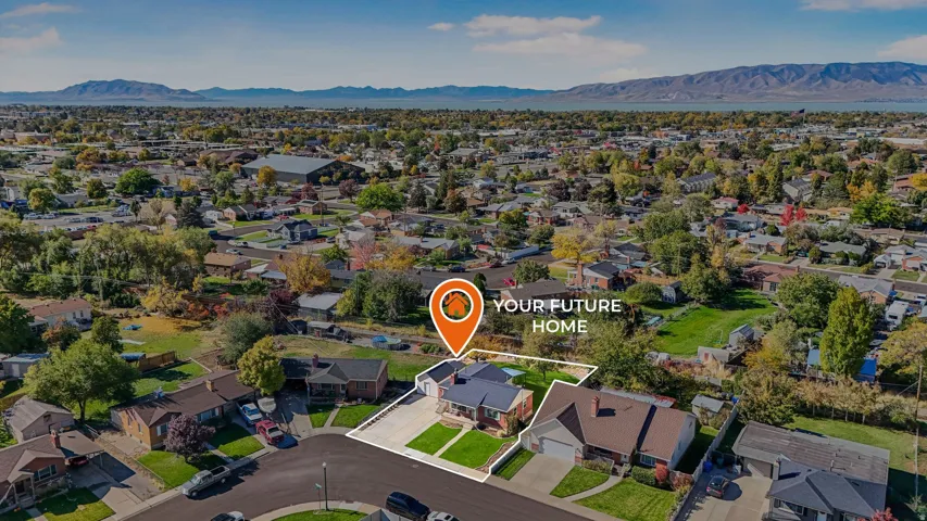 Aerial view of property's location with a mountain backdrop and nearby suburban area