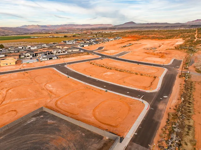Aerial view of residential area with a mountainous background and a desert landscape