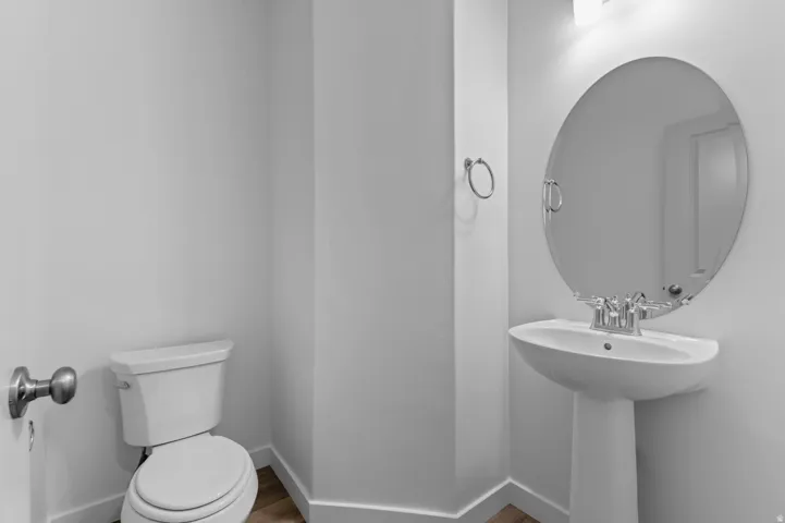 Bathroom featuring toilet and wood finished floors