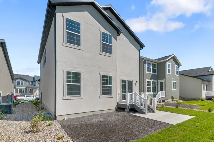 Rear view of property with stucco siding