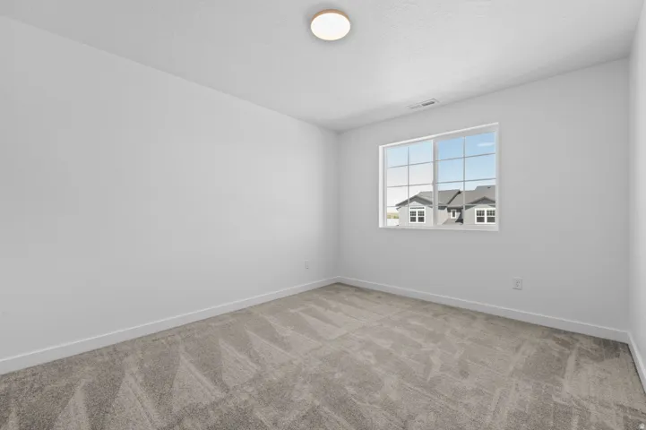 Unfurnished room featuring baseboards and light colored carpet