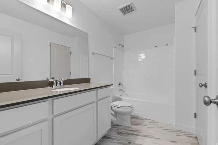 Full bathroom with washtub / shower combination and vanity