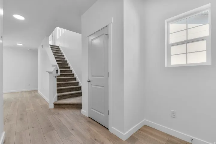Basement with light wood finished floors and baseboards