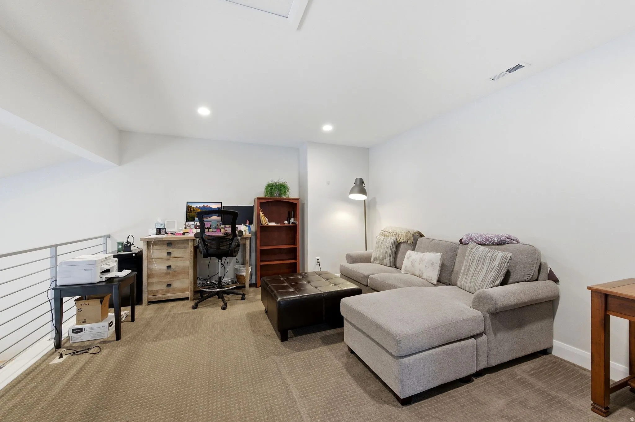 Carpeted office space featuring recessed lighting