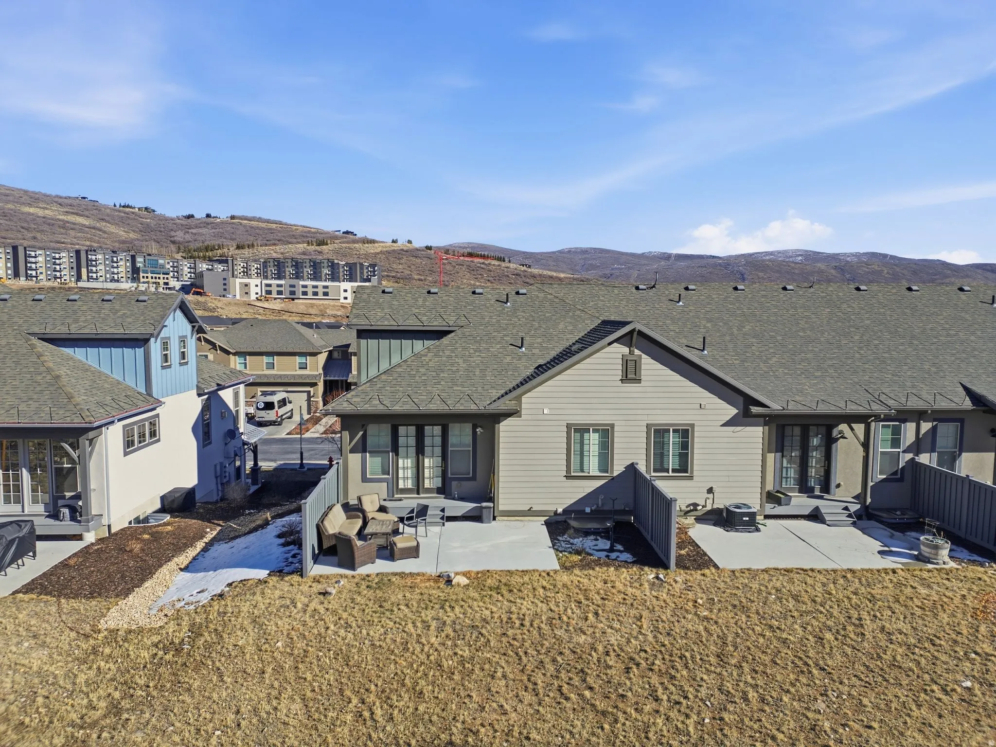 Rear view of property with a patio, a mountain view, a shingled roof, and outdoor lounge area