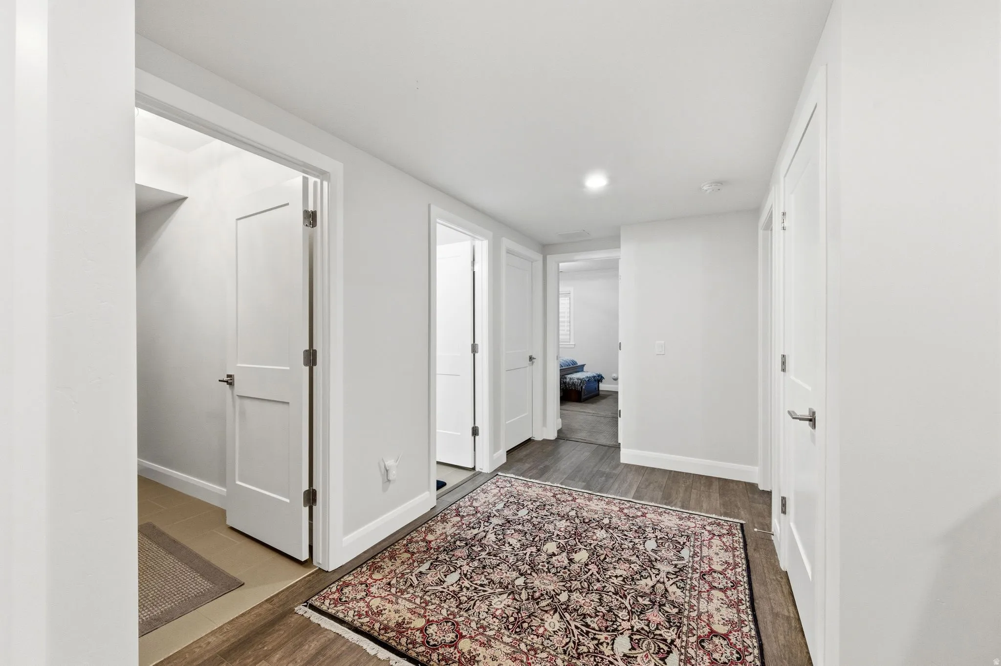 Corridor with dark wood finished floors and recessed lighting