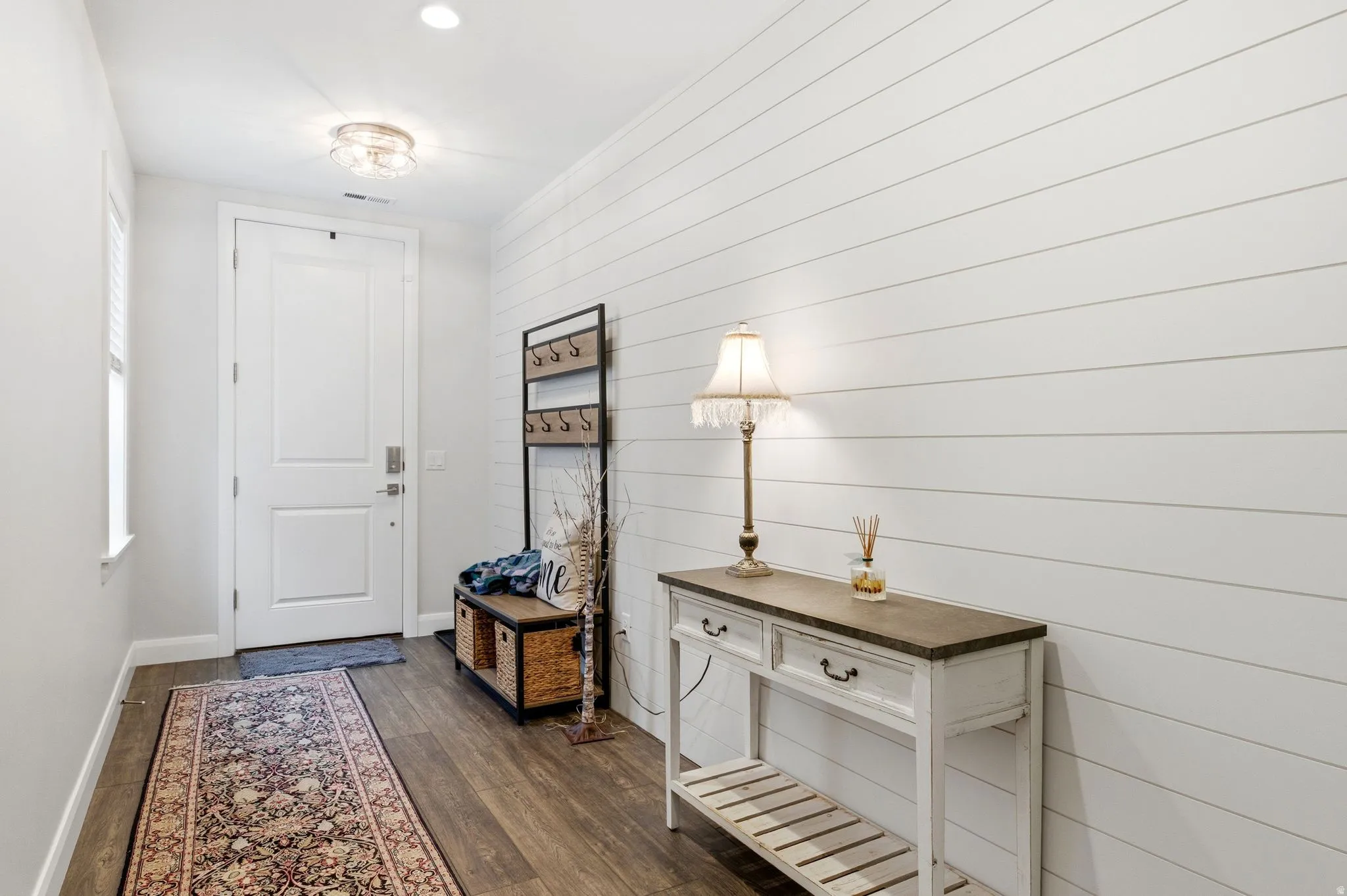 Foyer entrance featuring baseboards and dark wood finished floors