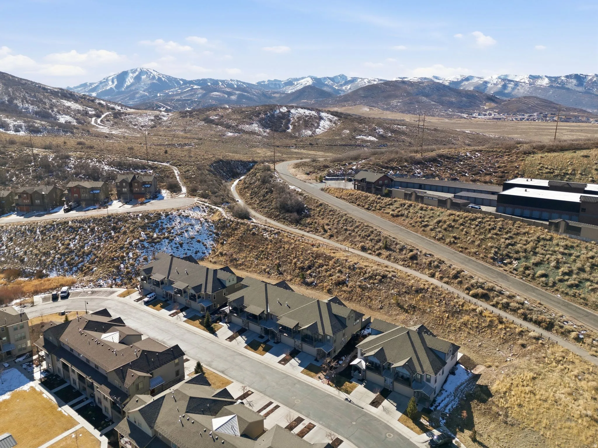 Aerial perspective of suburban area with a mountain backdrop
