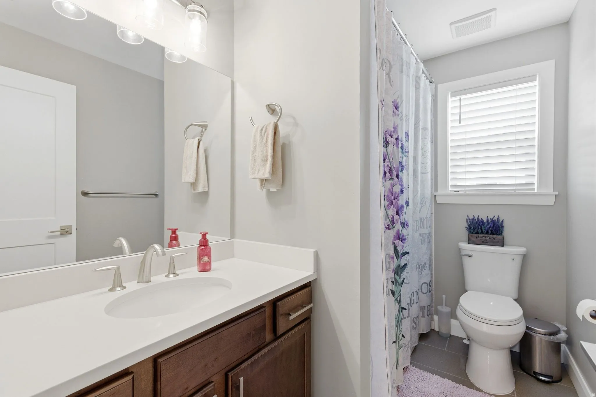 Bathroom with vanity, a shower with curtain, and tile patterned floors