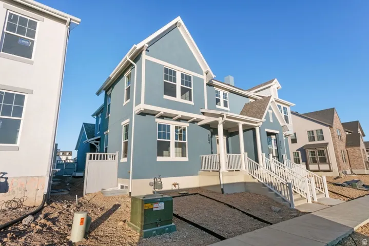 View of front facade featuring stucco siding