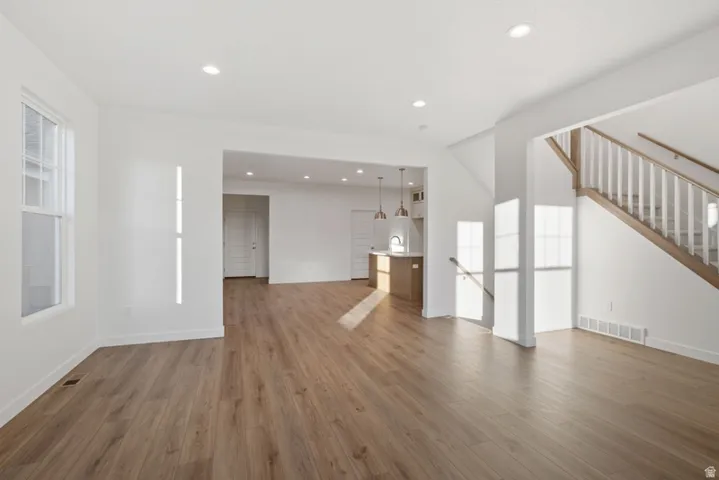 Unfurnished living room featuring light wood-style floors and recessed lighting