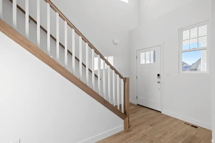 Entryway featuring light wood finished floors and a high ceiling