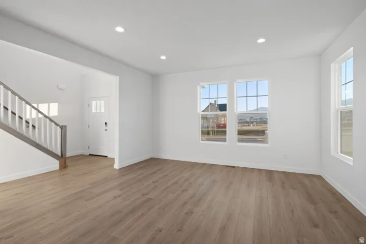 Unfurnished living room with light wood-style flooring and recessed lighting