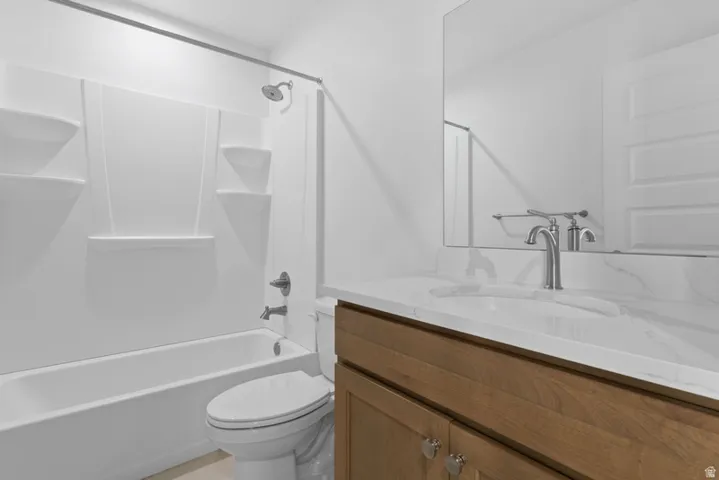 Full bath featuring vanity and shower / bath combination