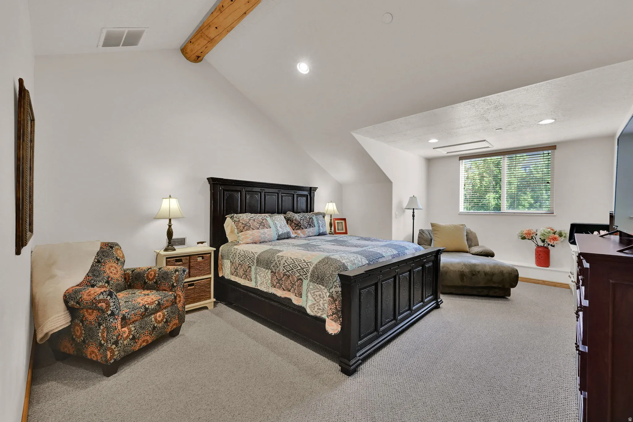 Bedroom with light carpet, recessed lighting, and vaulted ceiling with beams