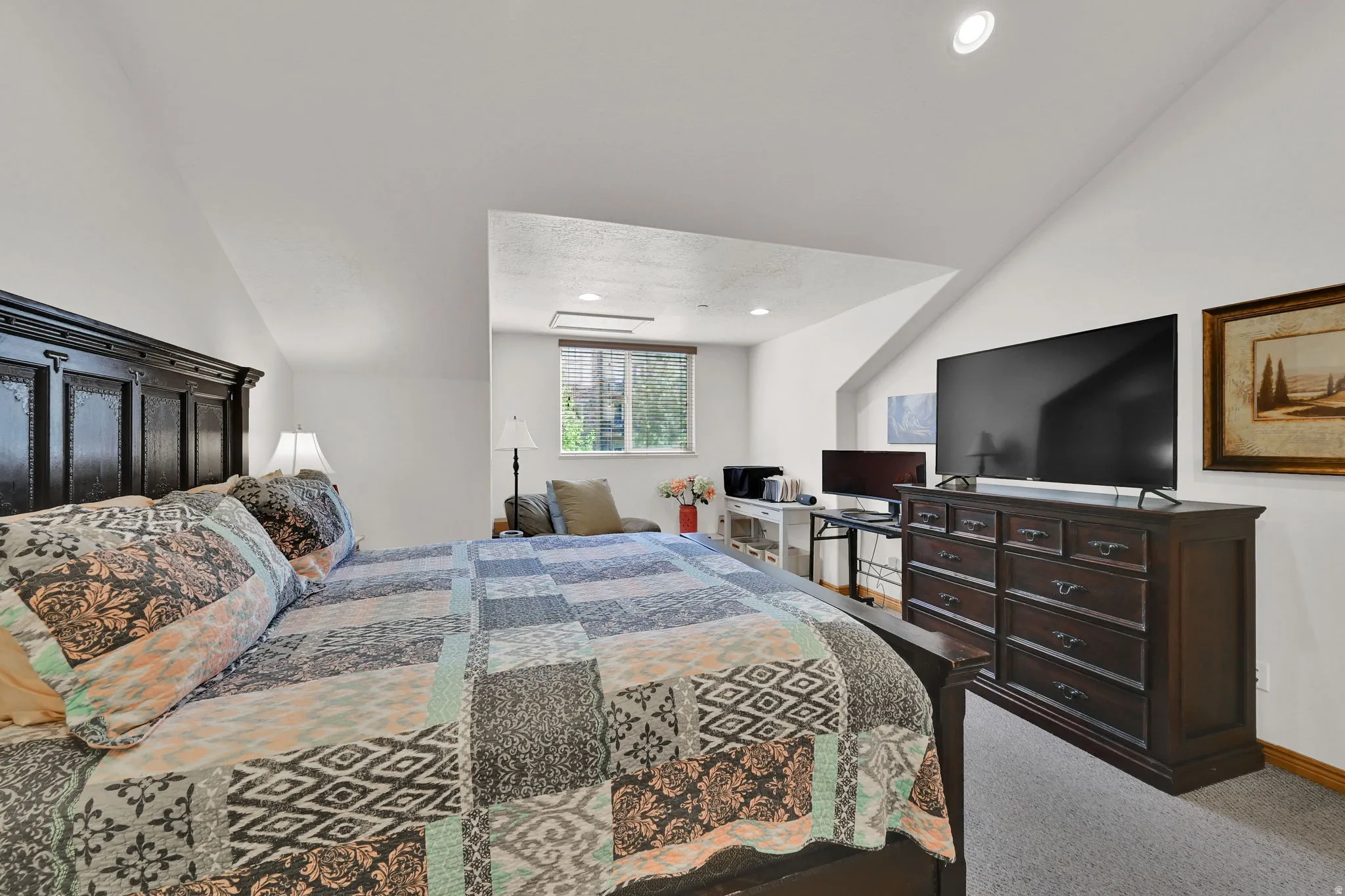 Bedroom with carpet floors, vaulted ceiling, and recessed lighting