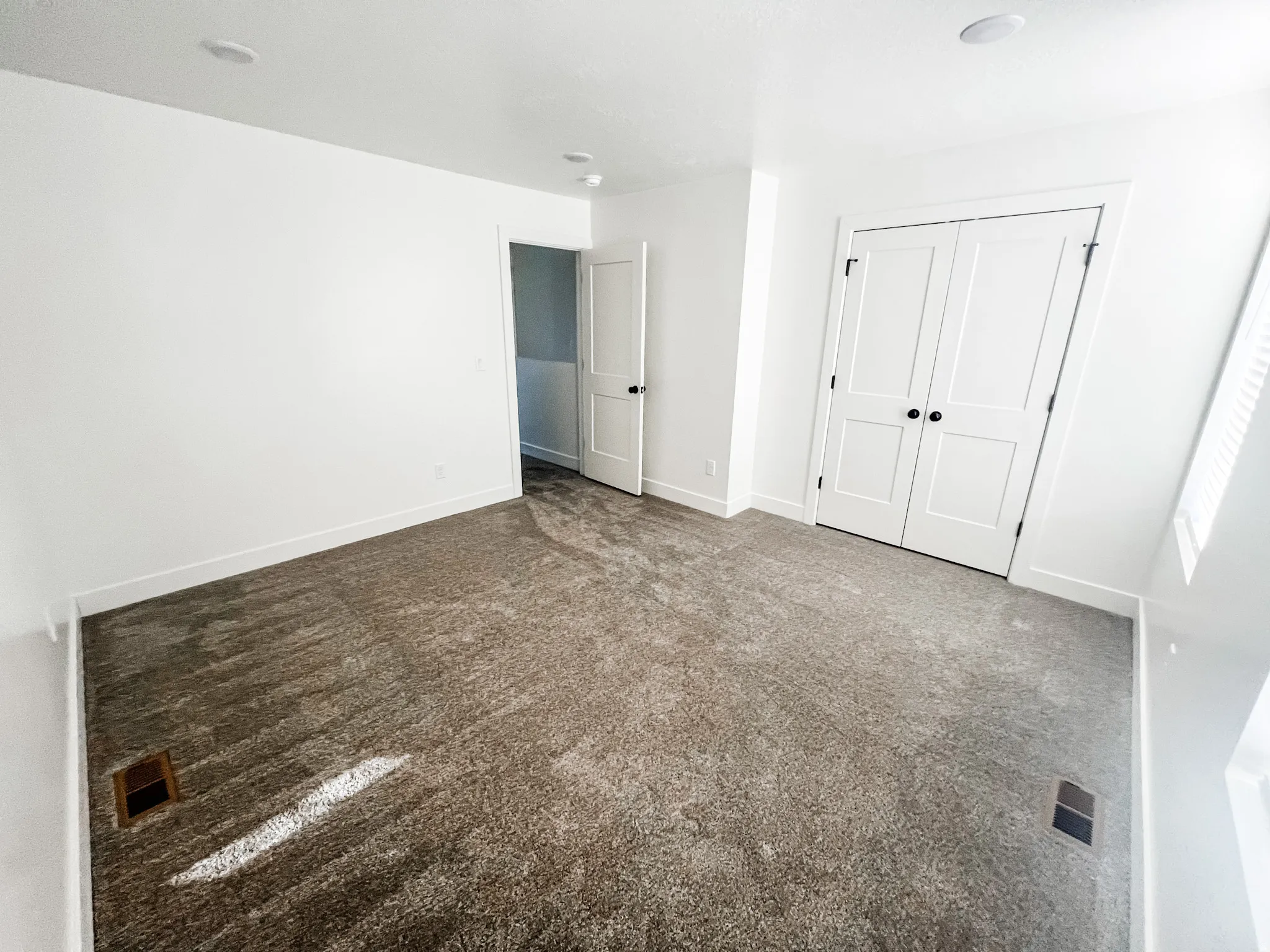 Unfurnished bedroom featuring dark carpet and a closet