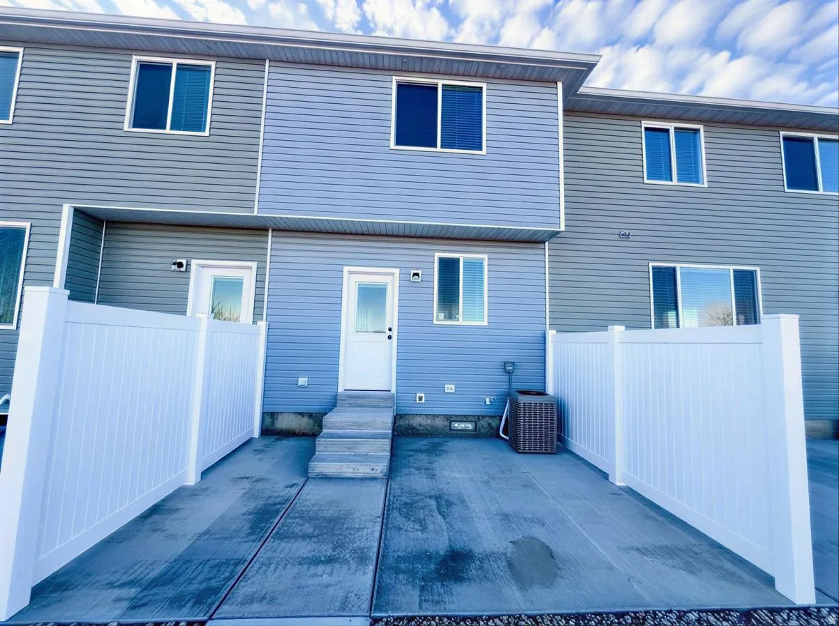 Back of property with a patio area and entry steps