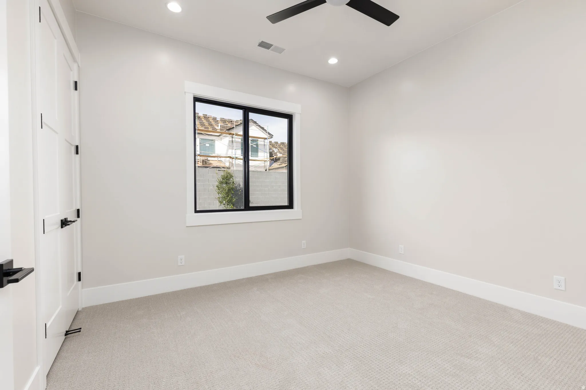 Spare room featuring light carpet, recessed lighting, and a ceiling fan