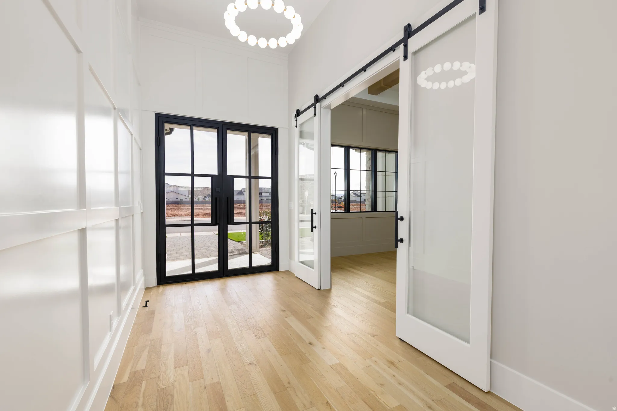 Entryway with a barn door and wood finished floors