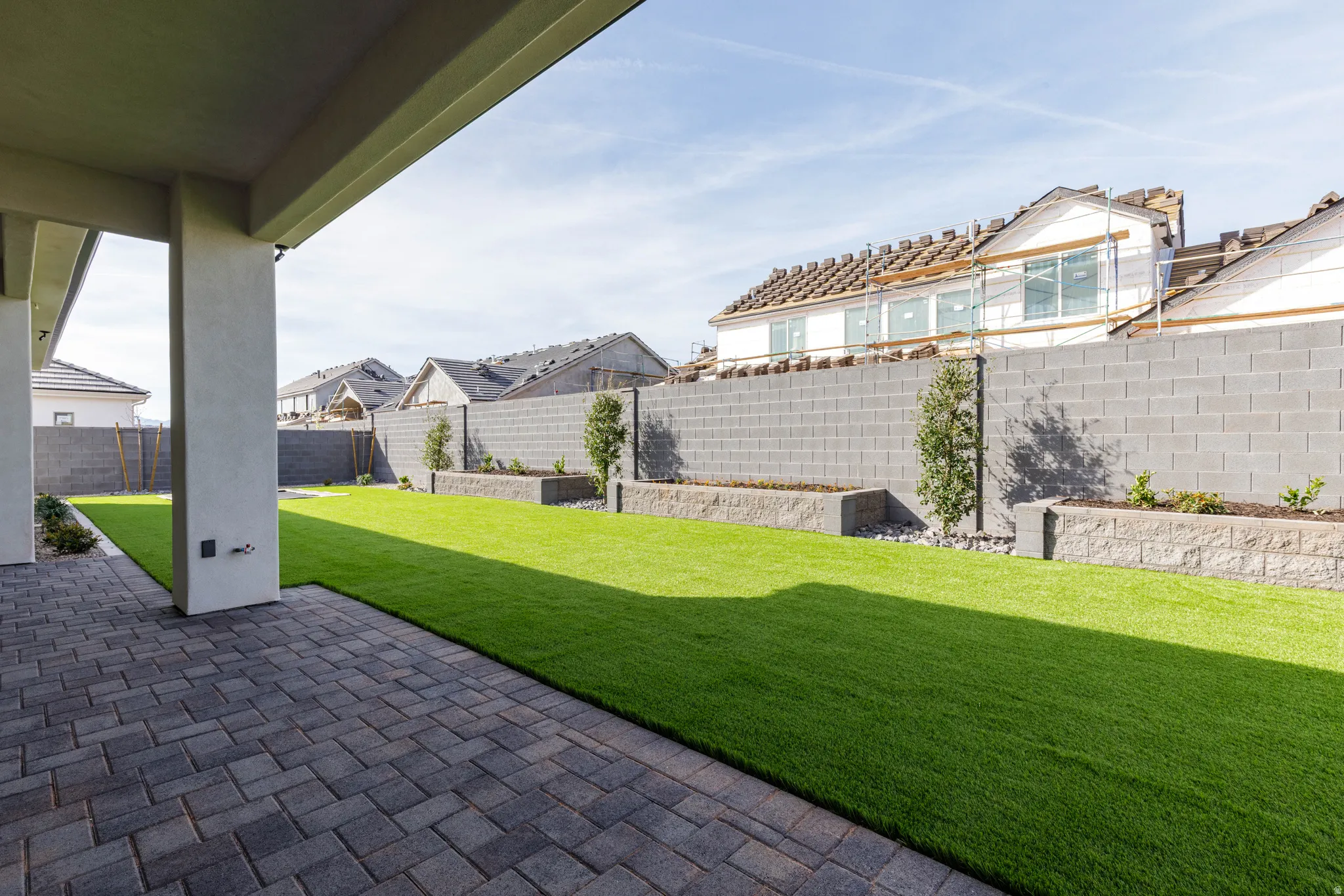 Fenced backyard with a patio and a residential view