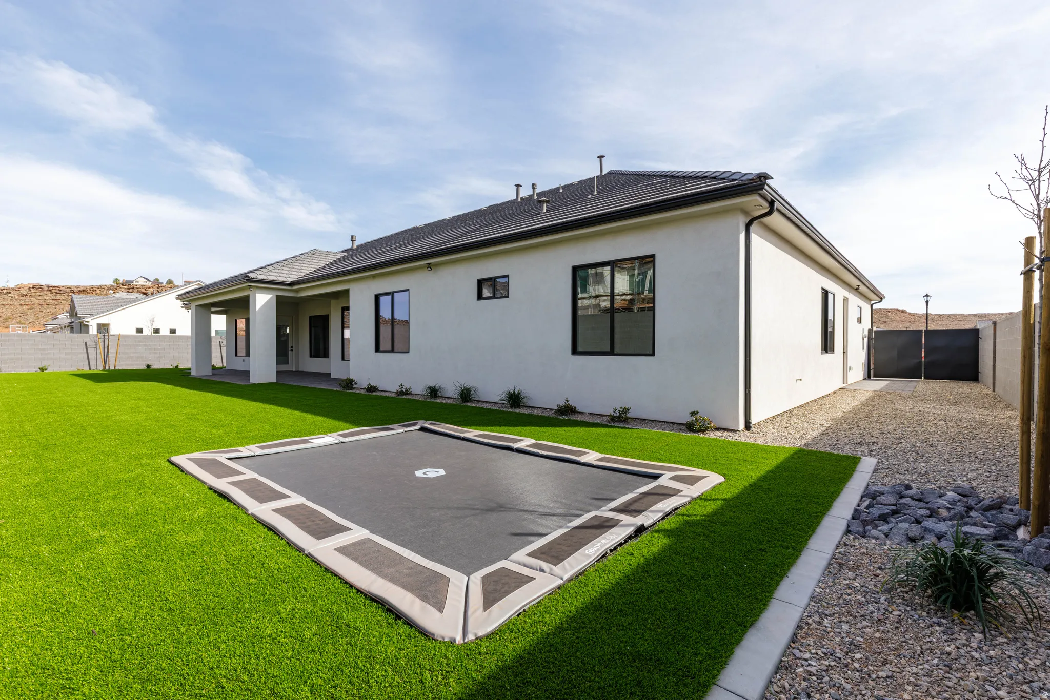 Rear view of property with a patio, a fenced backyard, and stucco siding