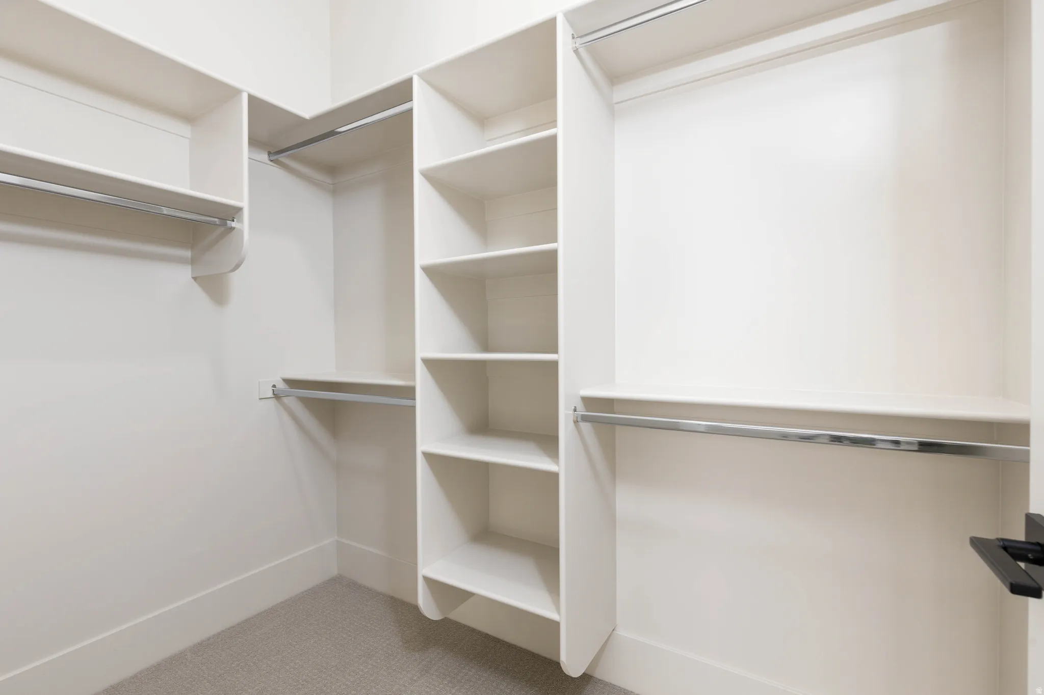 Walk in closet featuring light carpet