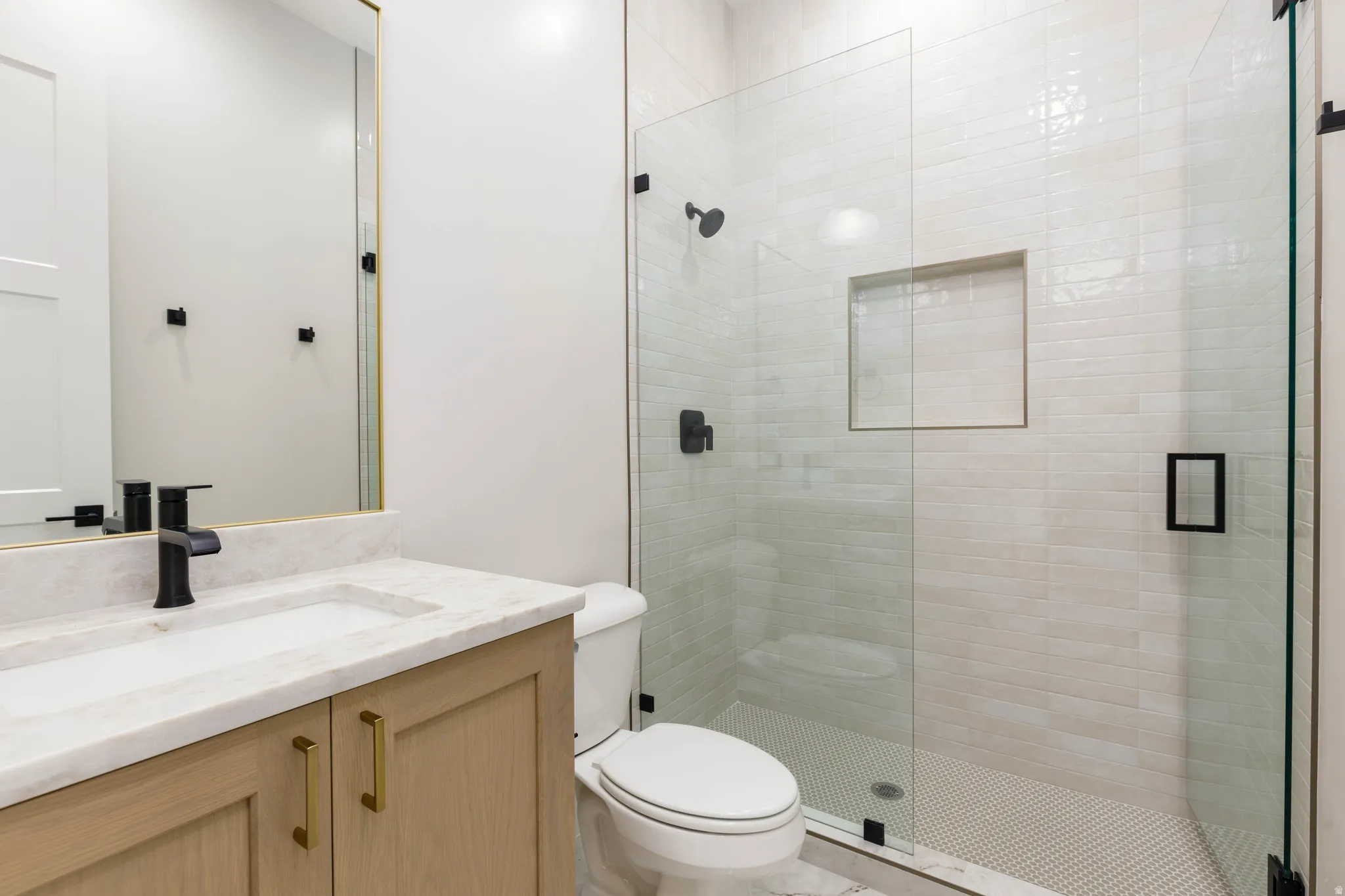 Full bathroom with vanity and a shower stall