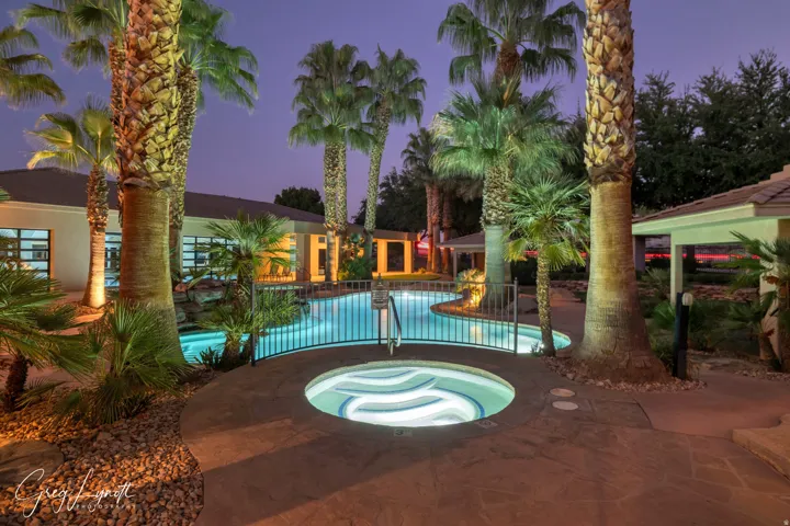 Outdoor pool featuring a patio area and an in-ground hot tub