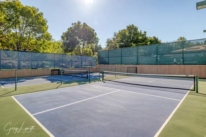 View of tennis court featuring community basketball court